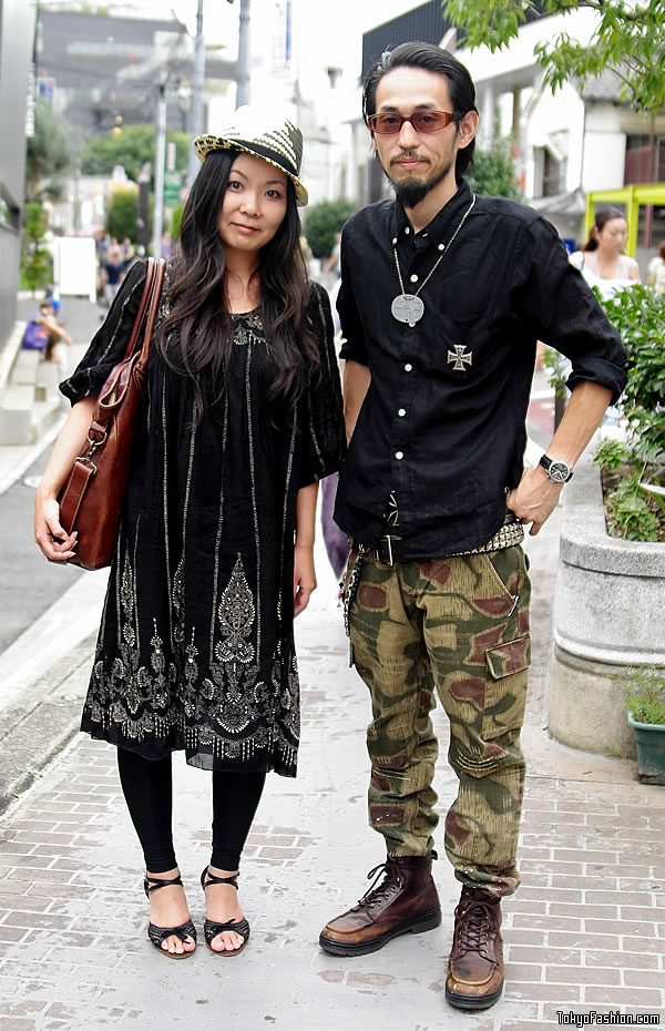 The girl he's with is wearing a black and white straw hat, a black pattern 