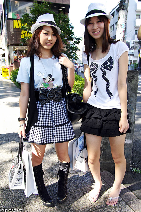 The girl on the right is wearing a jeweled t-shirt with a big bow, 