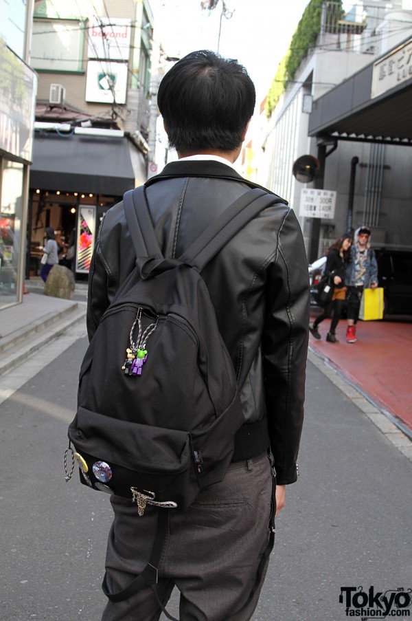 Black packpack and hanging suspenders in Harajuku