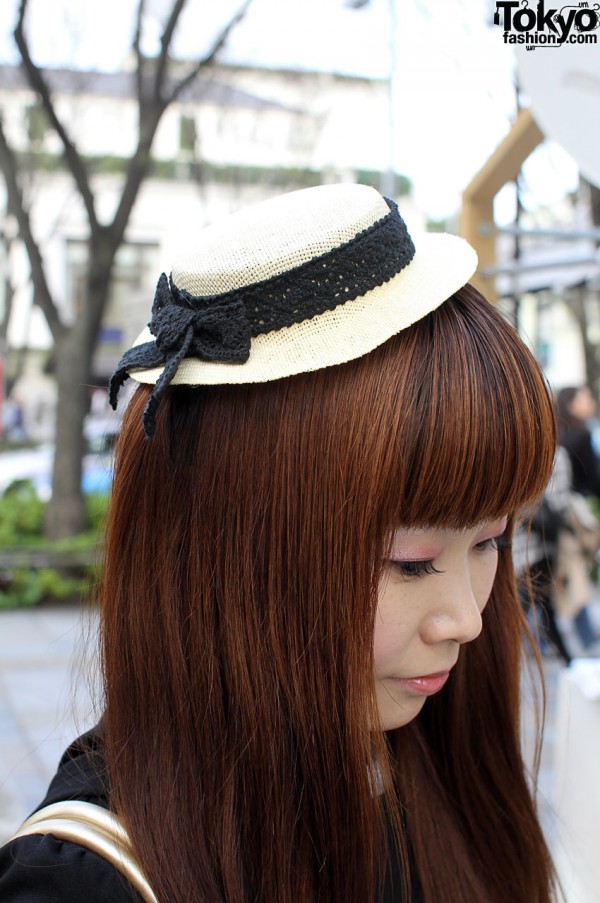 Small straw hat and long auburn hair