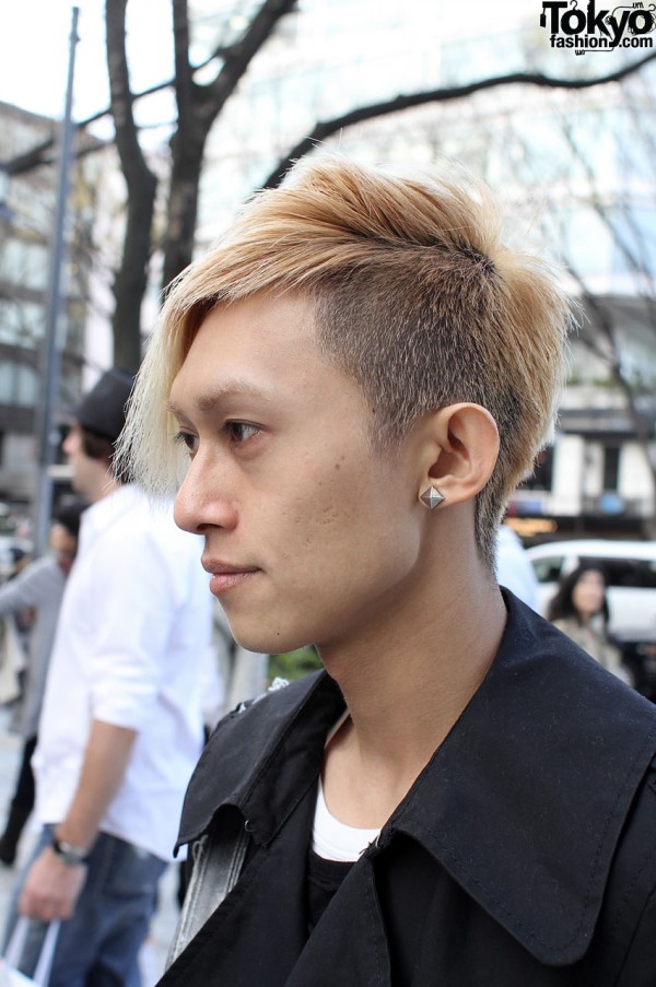 Trendy blonde haircut and silver stud earring.