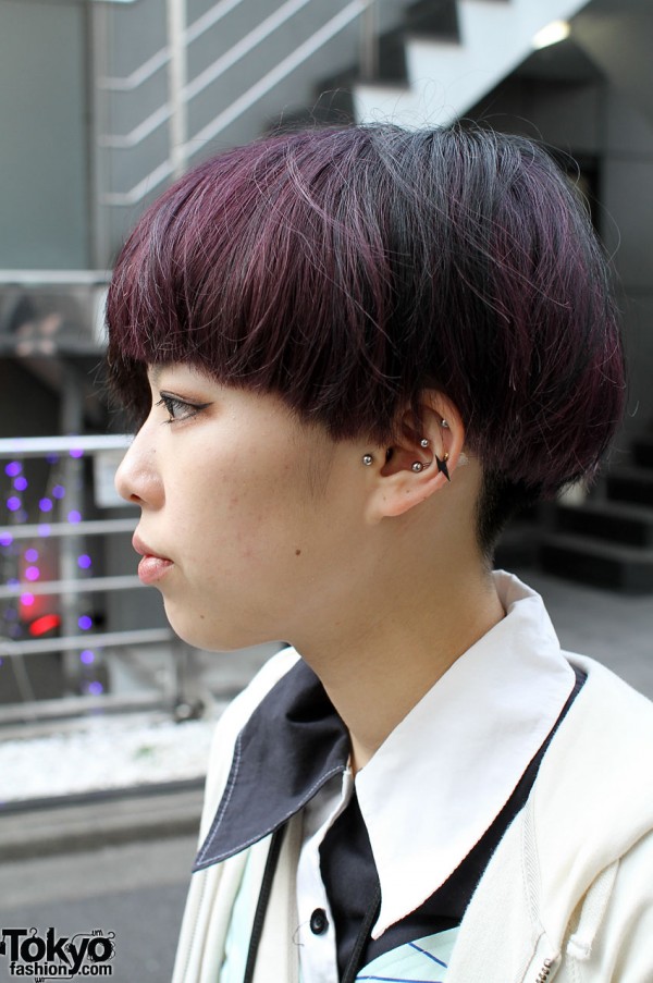 Trendy haircut, violet highlights and ear studs