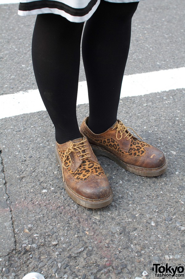 Black tights and two-tone Dr. Martens shoes