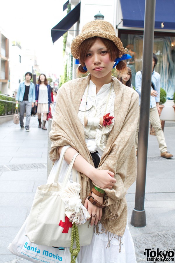 Fringed shawl and straw hat