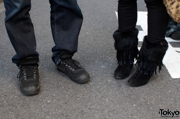 Black Nikes and fringed high heel boots