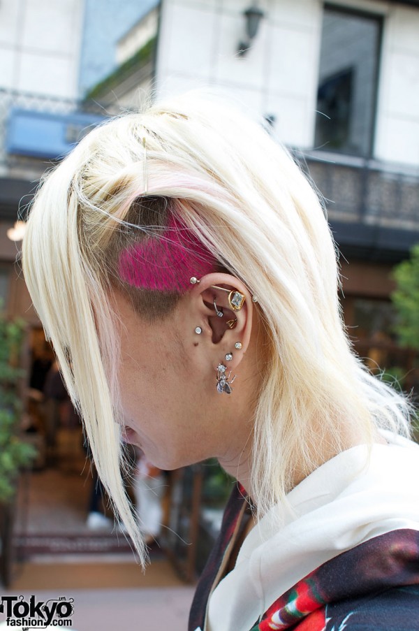 Blonde hair, shaved head, earrings and studs