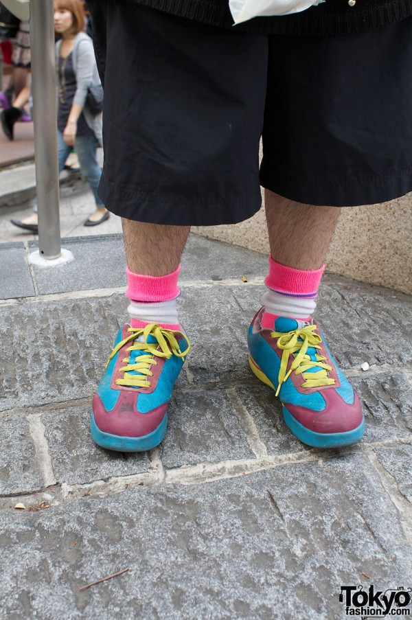Bright socks and sneakers with black shorts