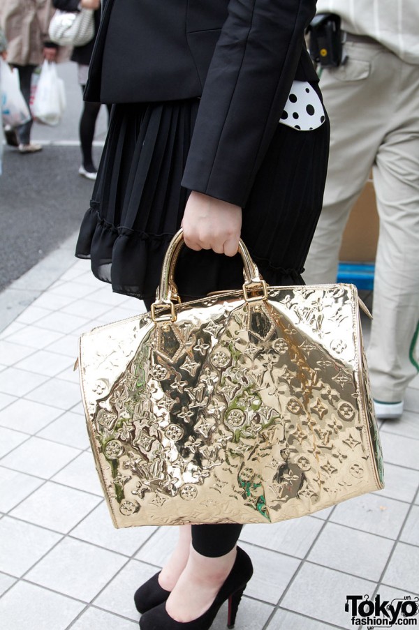 Gold Louis Vuitton bag and R&E stiletto shoes