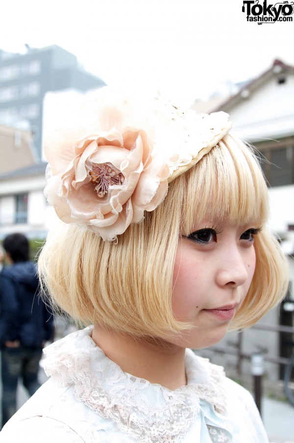 Cute blonde girl with small straw hat & large flower