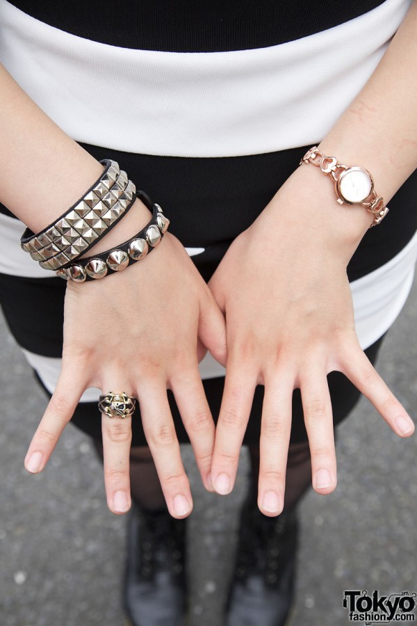 Studded wristbands, gold watch & gold skull ring