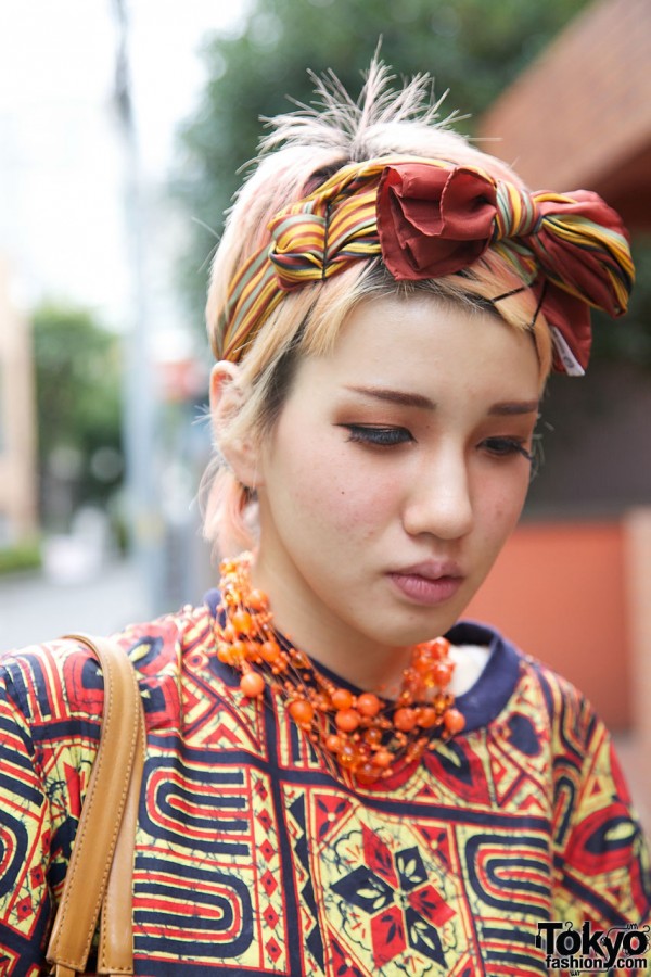 Scarf tied in bow & orange beads from UTA