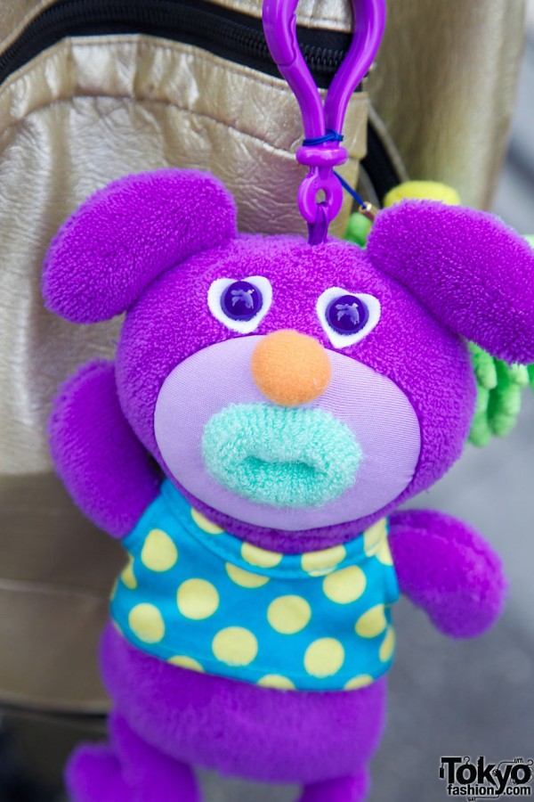 Purple bear toy on backpack