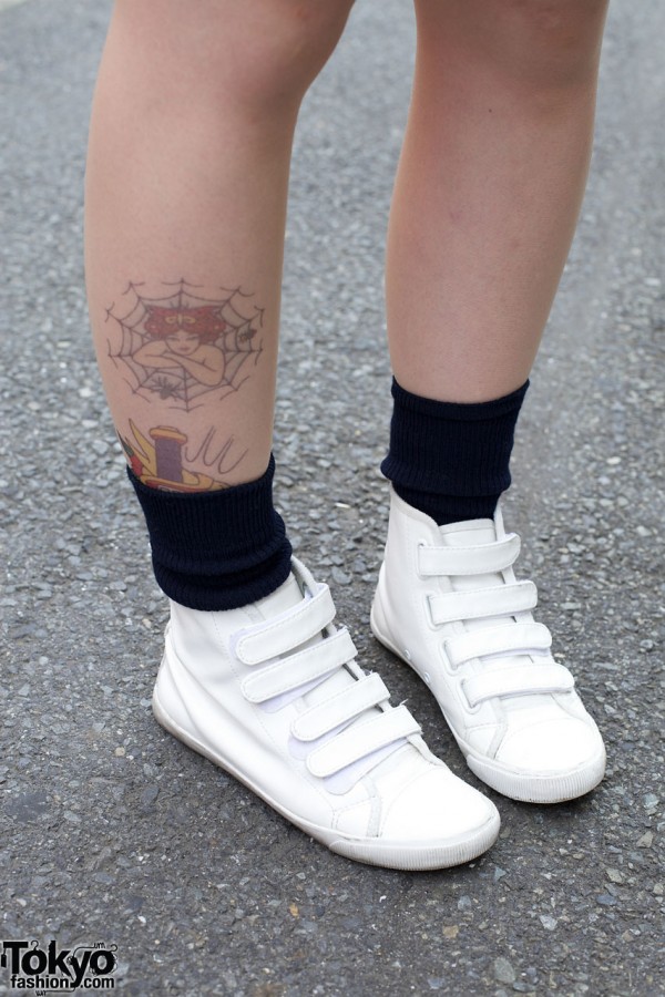 Ankle tattoo & white Velcro sneakers
