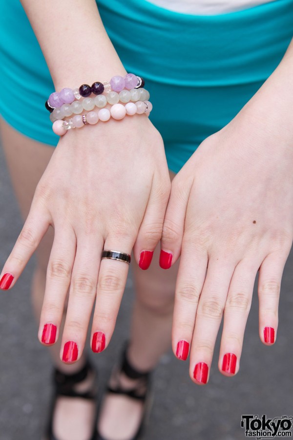 Beaded bracelet, black ring & red nails