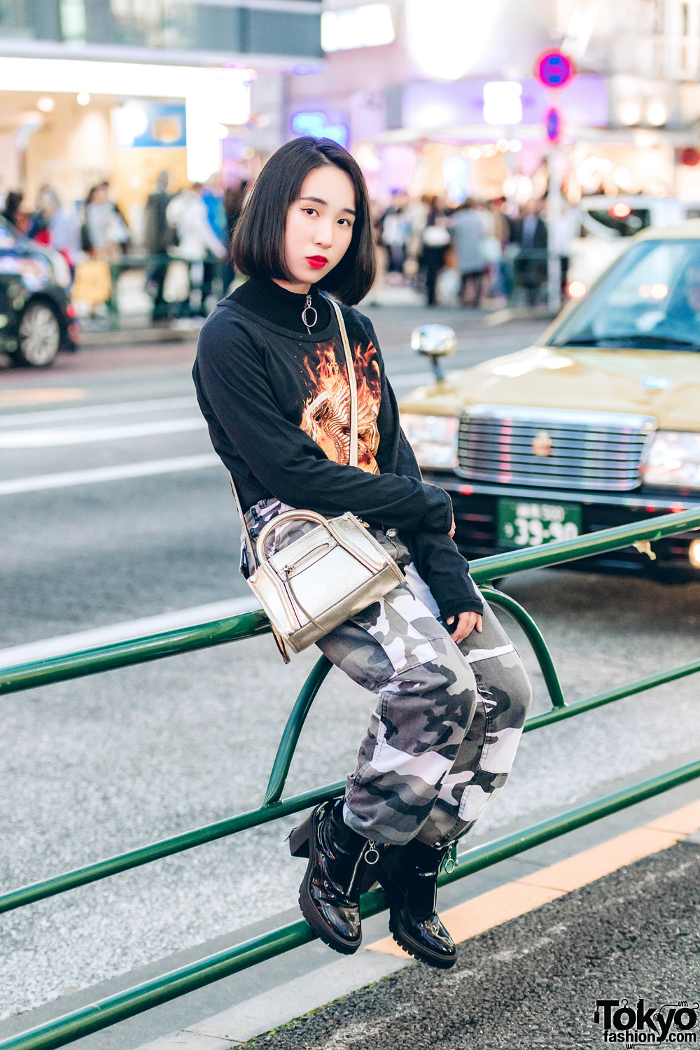 Tough-Chic Streetwear w/ Graphic Sweatshirt, Camouflage Pants & Black Leather Boots