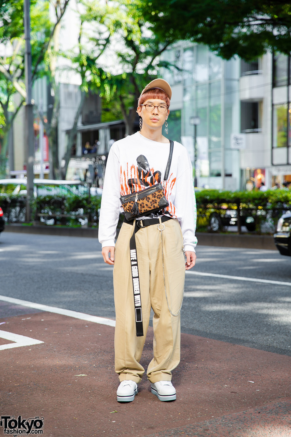 Japanese Videographer w/ Graphic Sweatshirt, Vintage Tan Pants, Animal Print Bag, Tan Hat & White Sneakers in Harajuku