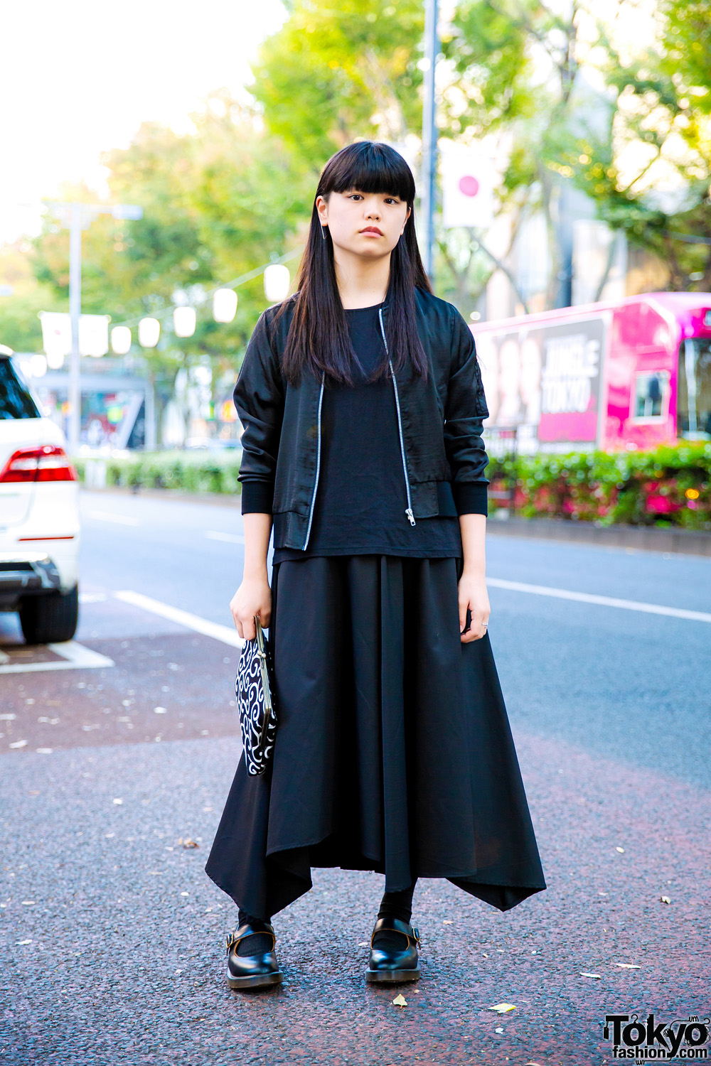 All Black Minimalist Street Style w/ Patterned Clutch, Heather Jacket, Uniqlo Top, Jeanasis Asymmetrical Skirt & Dr. Martens Mary Jane Shoes