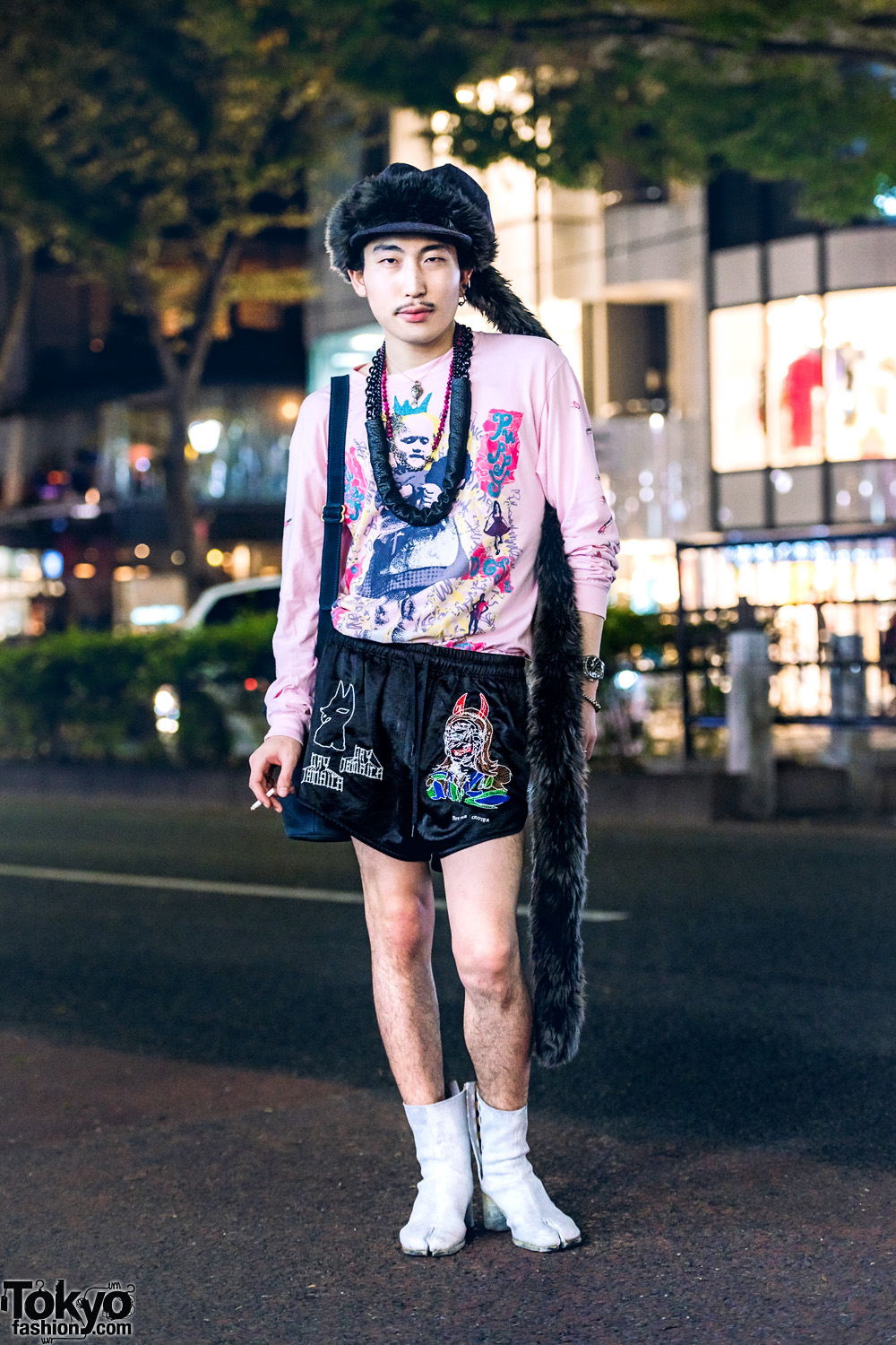 Japanese Artist in Statement-Making Streetwear Style w/ Blue Roses Graphic Sweater, Bernhard Willhelm Shorts, Maison Margiela Tabi Boots, Coach Bucket Bag & Gem Kingdom Accessories