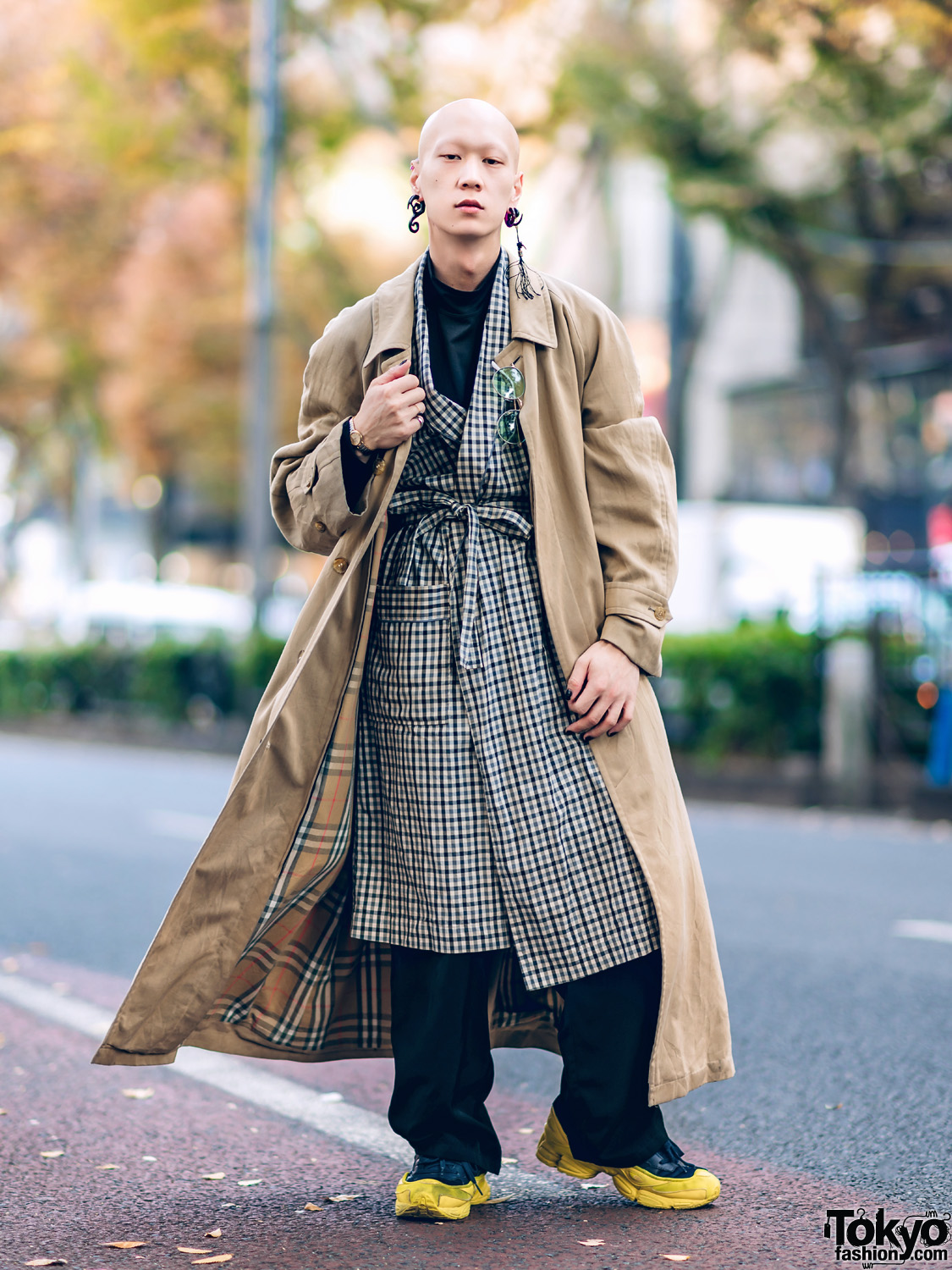 Japanese Model & Musician in Layered Outerwear Street Style w/ Burberry Coat, Plaid Liner, Face Shirt & Raf Simons Sneakers