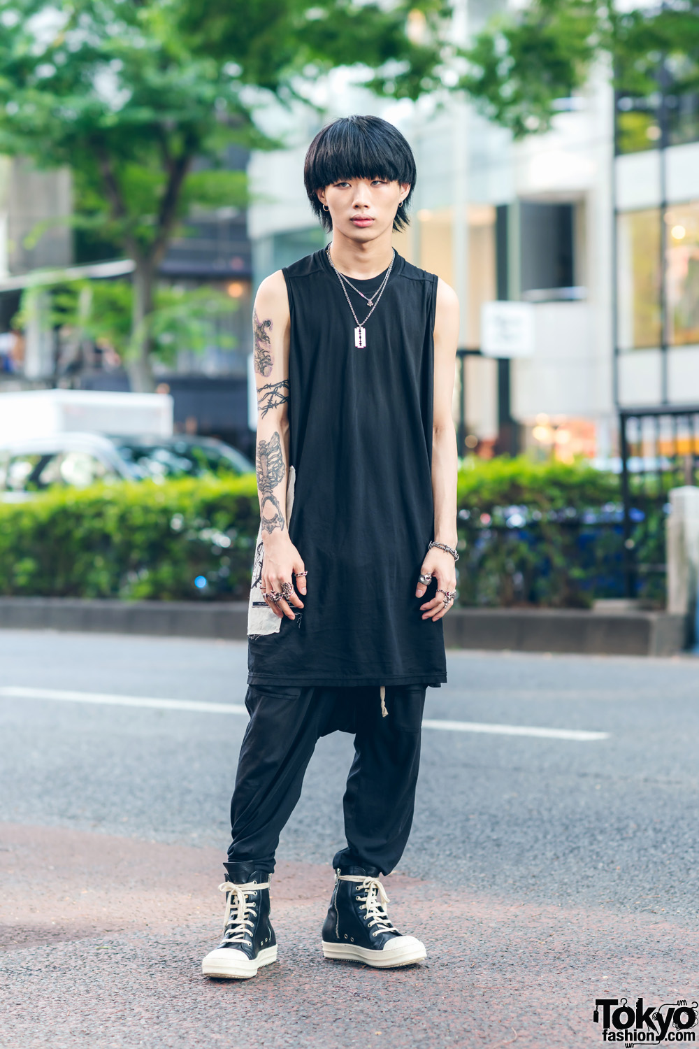Rick Owens Monochrome Streetwear Style w/ Arm Tattoos, I'm Praying To The Aliens Long Shirt, Loose Pants, Tokyo Human Experiments Rings & High Top Sneakers