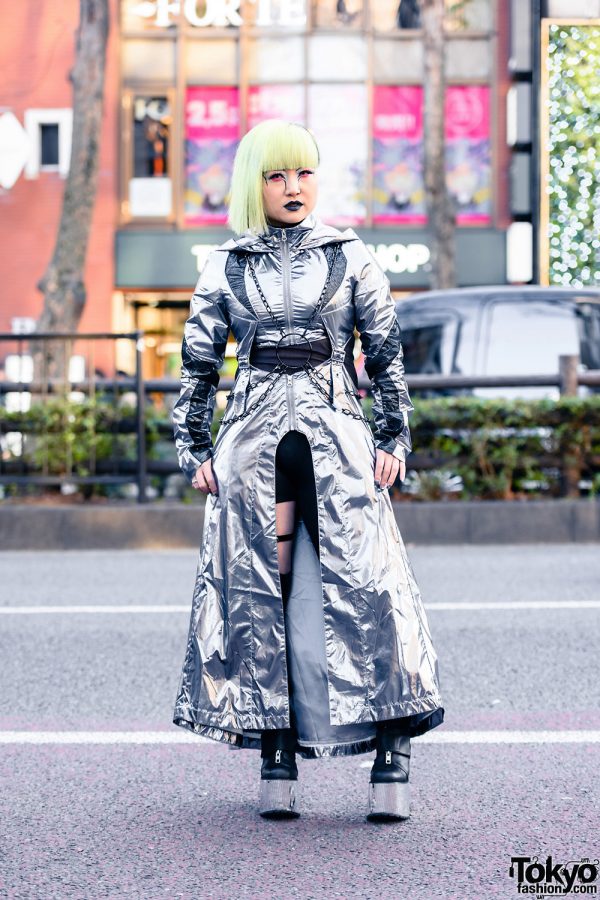 Dolls Kill Cyberpunk Harajuku Street Style w/ Striking Makeup, Asymmetrical Bob, Metallic Hooded Dress, Chain Harness, Cutout Tights & Platform Boots
