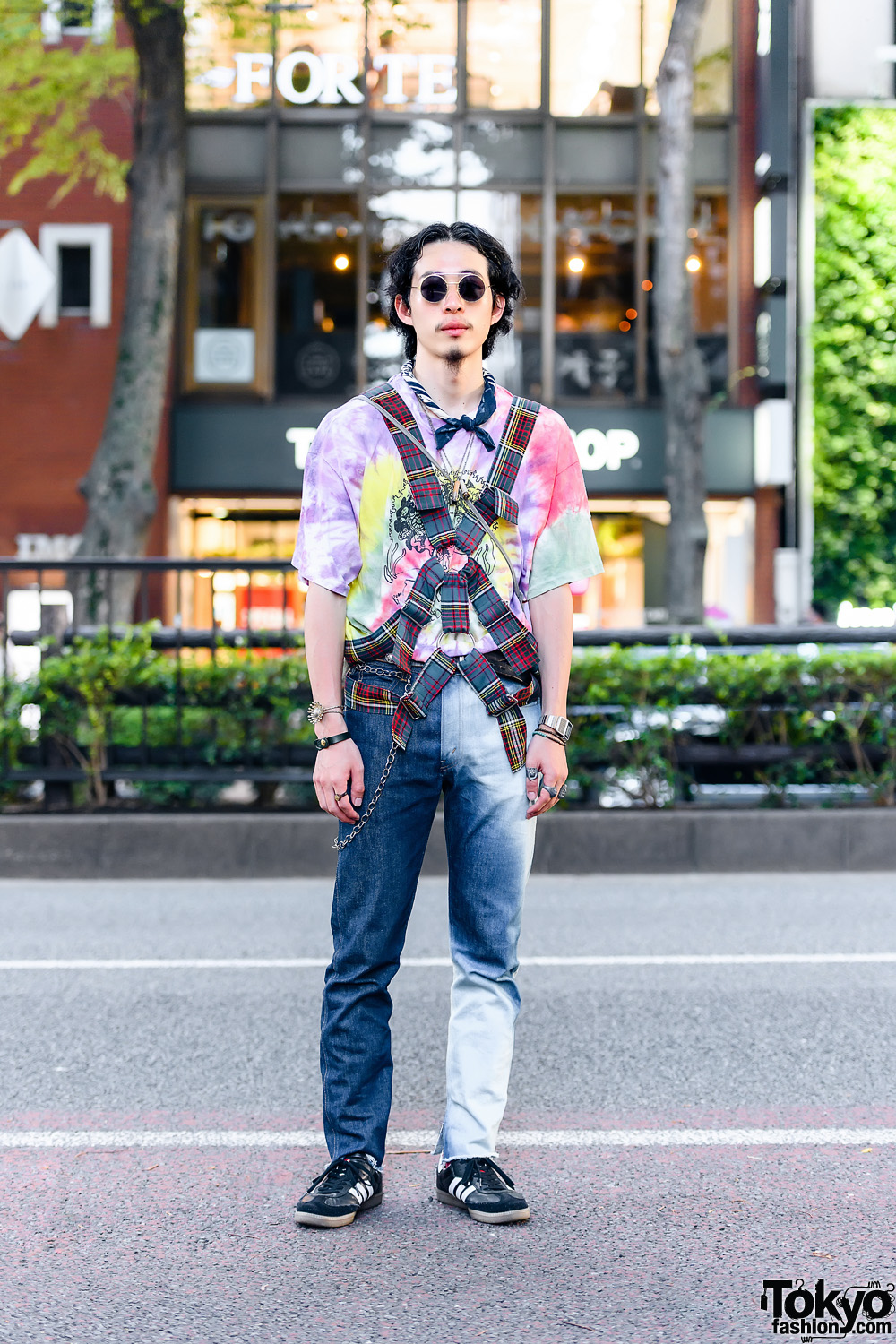 Student in Vintage Fashion w/ Body Harness, Round Sunglasses, Tie Dye Shirt, Levi's Jeans, Al's Attire Crossbody, Adidas Samba Classic Shoes, and Vintage Casio Watch