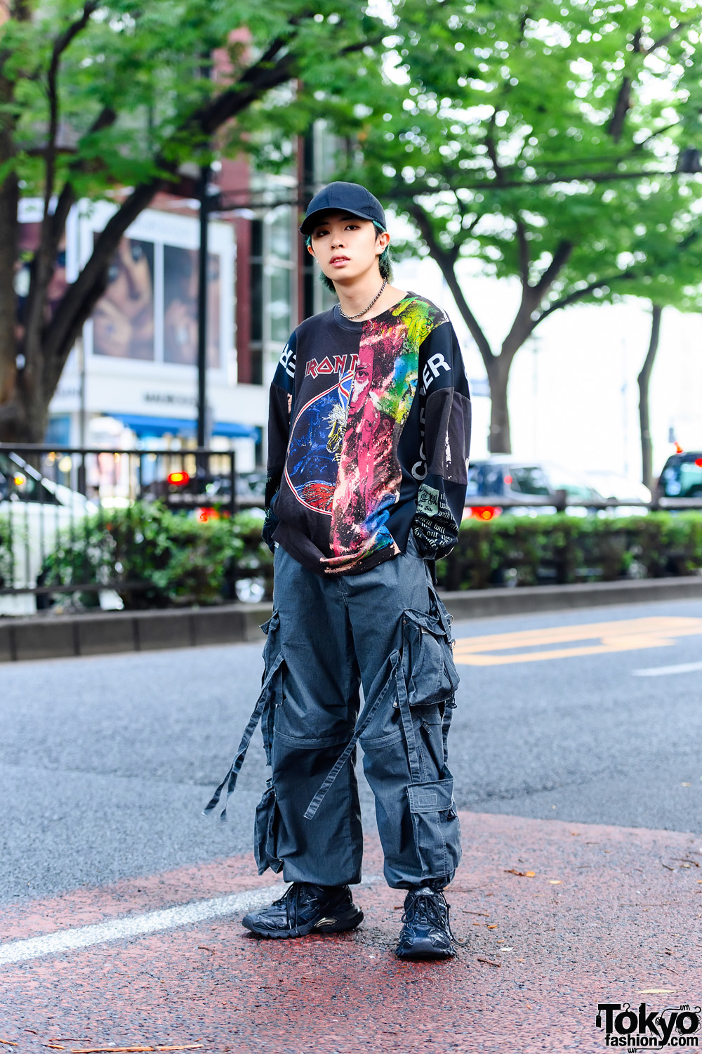 Japanese Model's Graphic Street Style in Tokyo w/ Green Hair, Black Cap, Cote Mer Iron Maiden Patchwork Shirt, Convertible Pants & Balenciaga Track.2 Sneakers