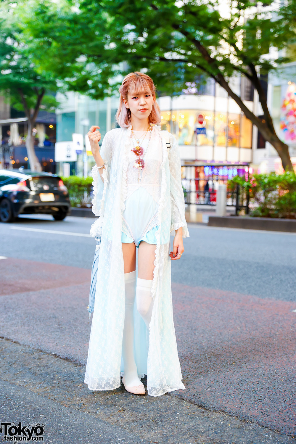 Fashion Designer in White Lace Romper, Thigh-High White Stockings, H&M Ballerina Flats, Resale Polka Dot Sling Bag, Rose Tint Sunglasses, Medallion Necklaces, Rosary Necklace & Stone-Embellished Rings